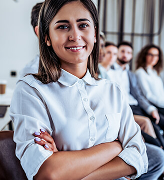 Close up of a smiling woman with a group of people behind her